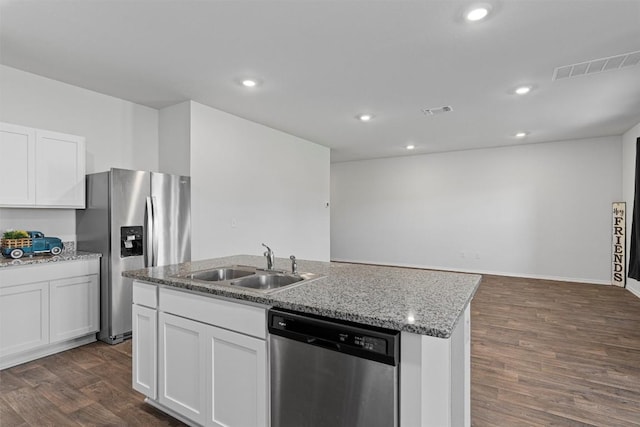 11104 Roving Pass, Elgin, TX 78621 - kitchen featuring dark wood finished floors, a sink, white cabinetry, stainless steel appliances, and an island with sink