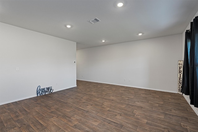 spare room with dark wood-type flooring