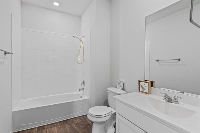 11104 Roving Pass, Elgin, TX 78621 - bathroom featuring vanity, toilet, shower / bathtub combination, and wood finished floors