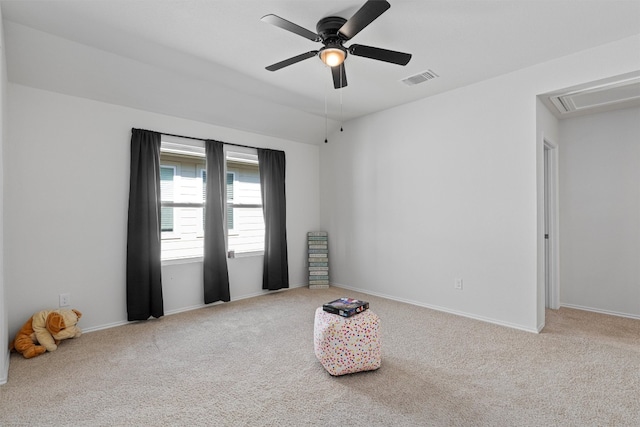 interior space featuring light carpet and ceiling fan