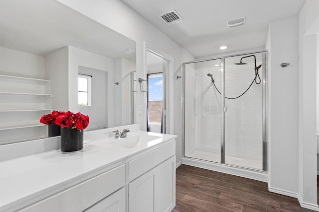 11104 Roving Pass, Elgin, TX 78621 - full bath featuring vanity, a shower stall, visible vents, and wood finished floors