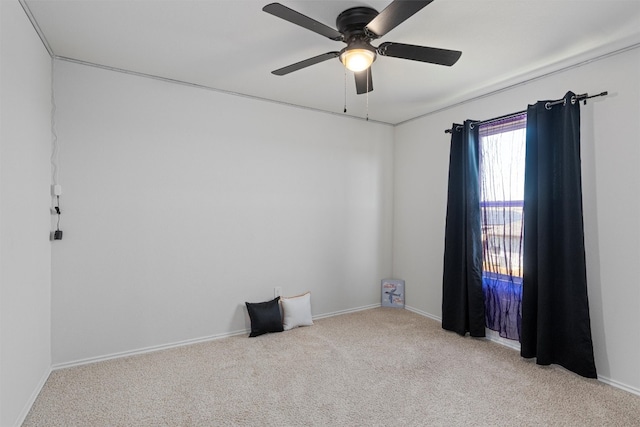 empty room featuring light colored carpet and ceiling fan