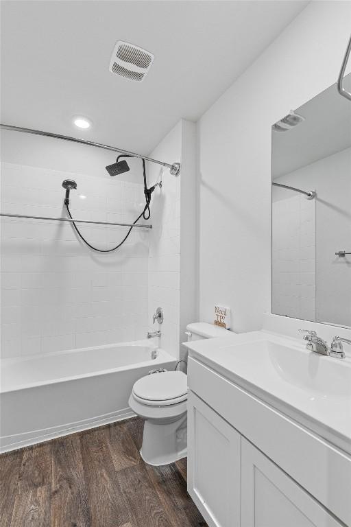11104 Roving Pass, Elgin, TX 78621 - full bathroom featuring toilet, wood finished floors, shower / bath combination, visible vents, and vanity