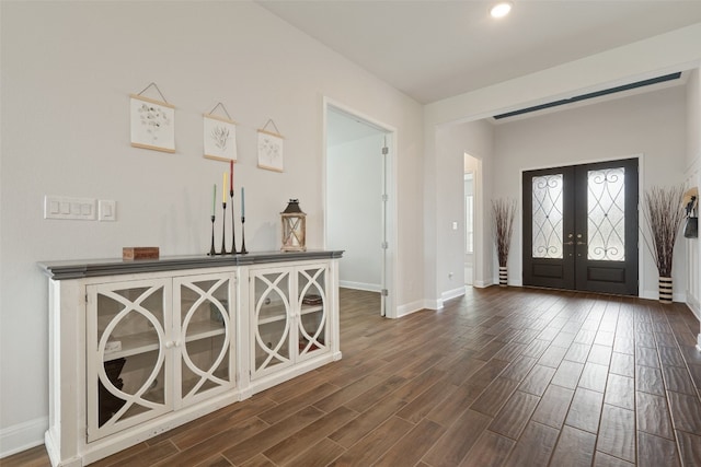 foyer entrance with french doors and dark hardwood / wood-style floors