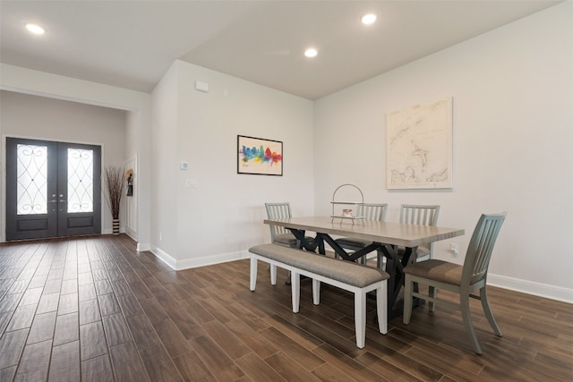 dining space with dark wood-type flooring and french doors