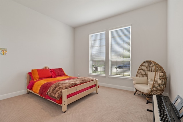 bedroom with light colored carpet and multiple windows