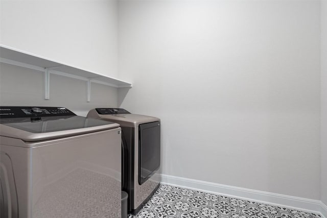 laundry room with washing machine and clothes dryer, laundry area, and baseboards