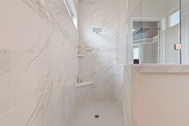 bathroom with a tile shower