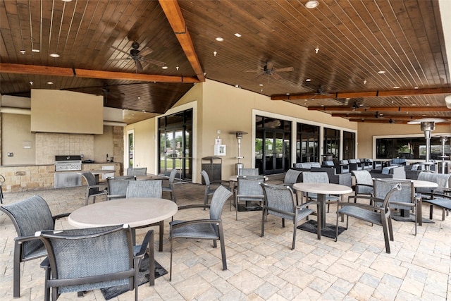 view of patio featuring a grill, exterior kitchen, and ceiling fan