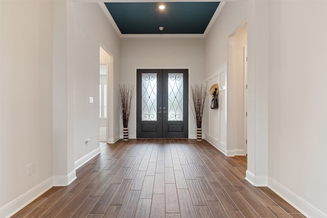 foyer featuring hardwood / wood-style floors, french doors, and ornamental molding