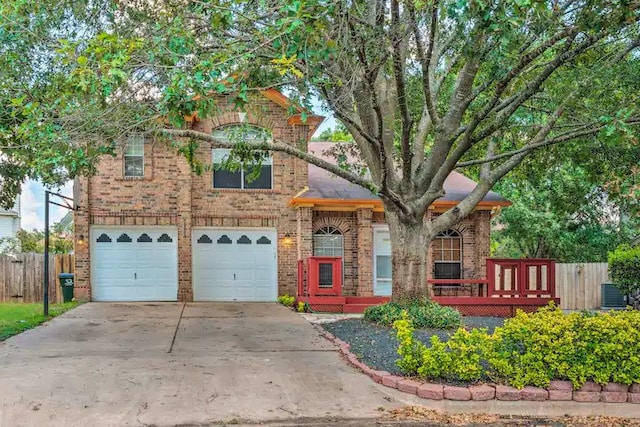 view of front of property featuring a garage and central AC unit