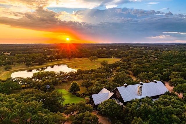 aerial view at dusk with a water view