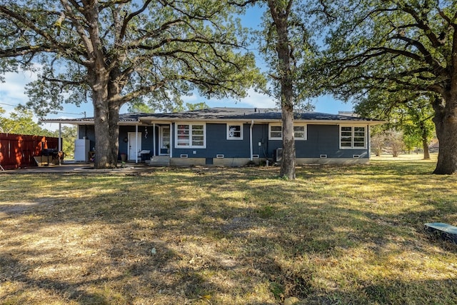 back of property featuring a lawn