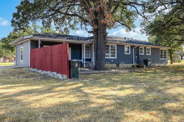 back of house featuring a lawn and central AC unit