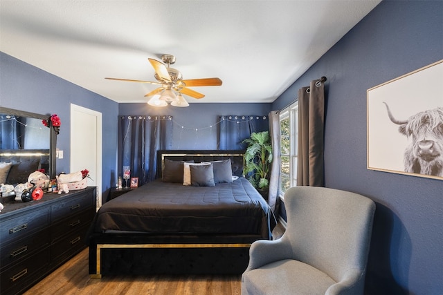 bedroom with hardwood / wood-style floors and ceiling fan