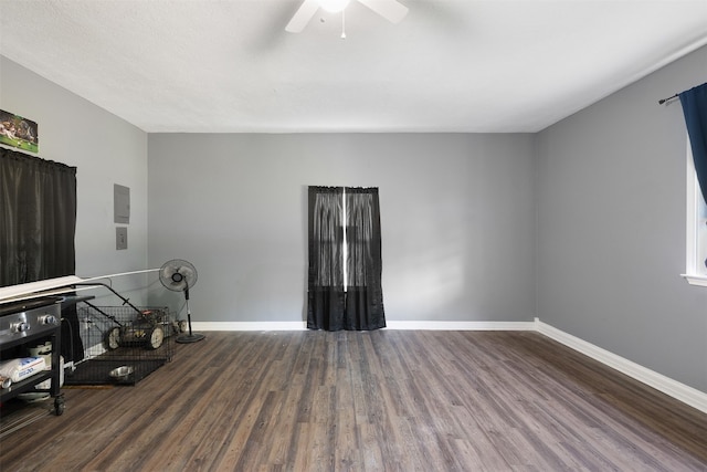 living room with ceiling fan and dark hardwood / wood-style flooring