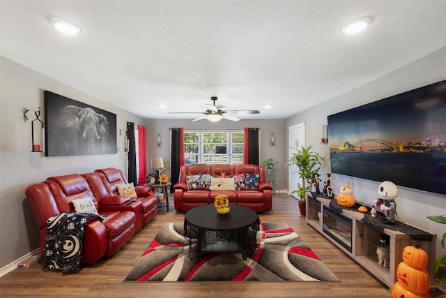 living room featuring hardwood / wood-style flooring and ceiling fan