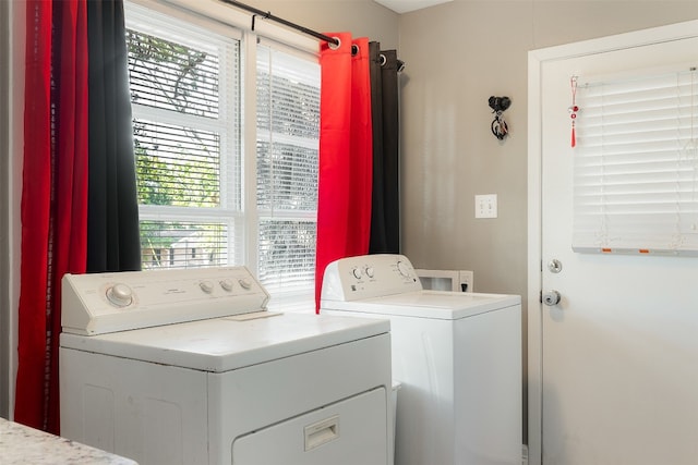 washroom with washer and clothes dryer and a wealth of natural light