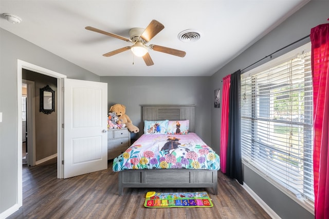 bedroom with dark wood-type flooring and ceiling fan