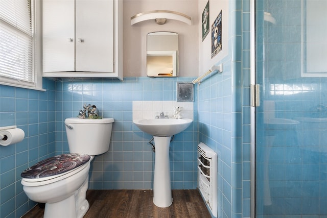 bathroom featuring toilet, tile walls, walk in shower, and hardwood / wood-style floors