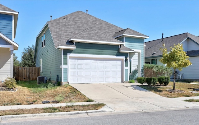 front of property with cooling unit and a garage