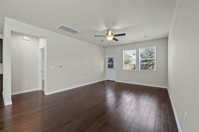 spare room featuring ceiling fan and dark hardwood / wood-style flooring