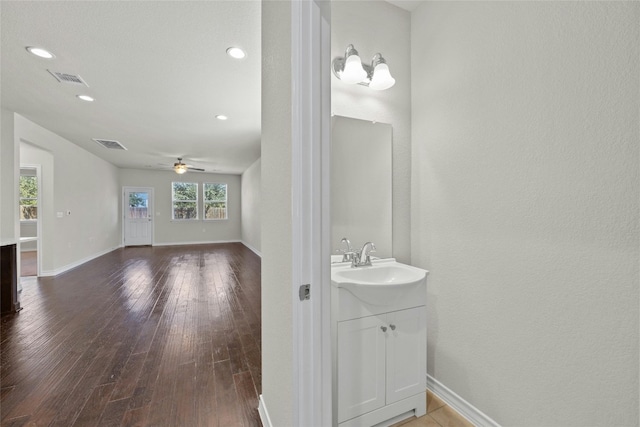 bathroom with vanity, hardwood / wood-style flooring, and ceiling fan