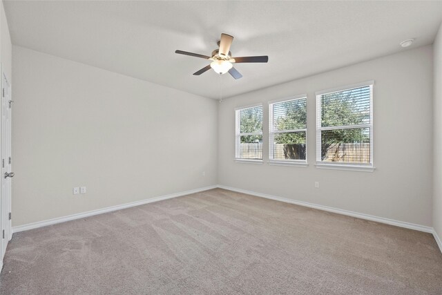 empty room with light carpet and ceiling fan