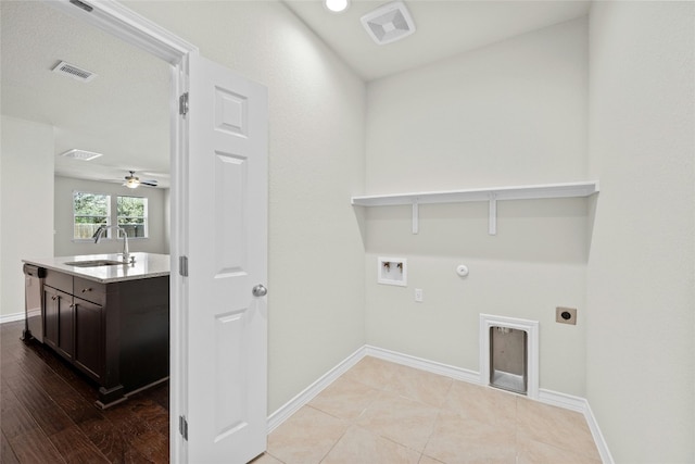 laundry room with washer hookup, light wood-type flooring, electric dryer hookup, hookup for a gas dryer, and sink