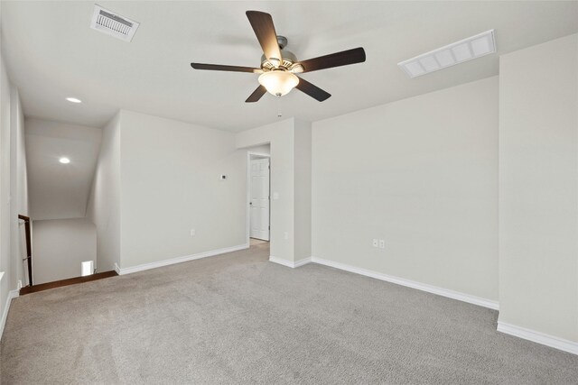 carpeted spare room with ceiling fan