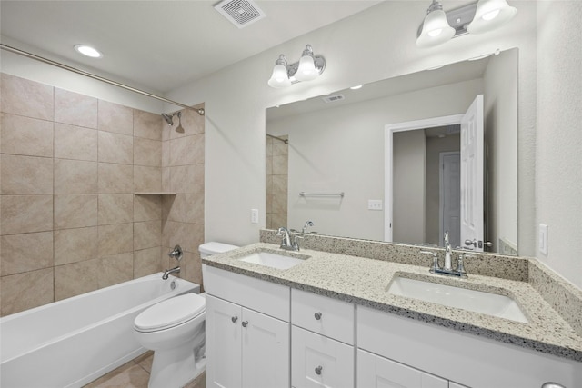 full bathroom with vanity, toilet, tiled shower / bath combo, and tile patterned flooring