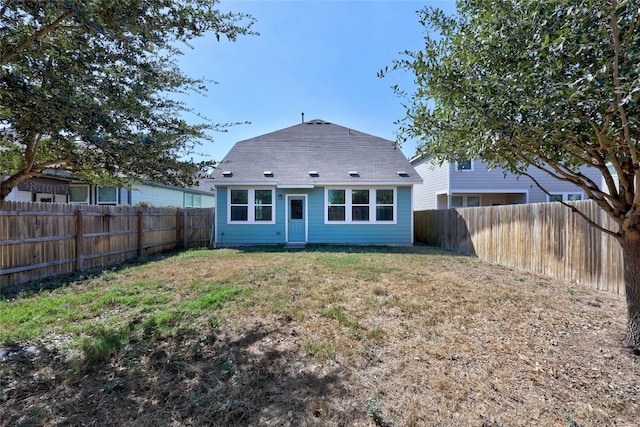 rear view of property with a yard