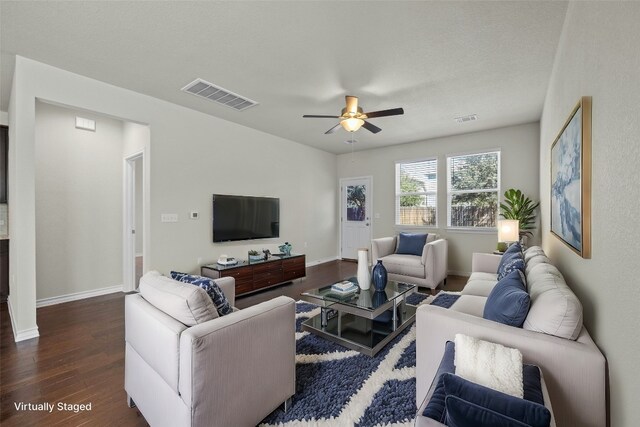 living room with dark hardwood / wood-style floors, a textured ceiling, and ceiling fan