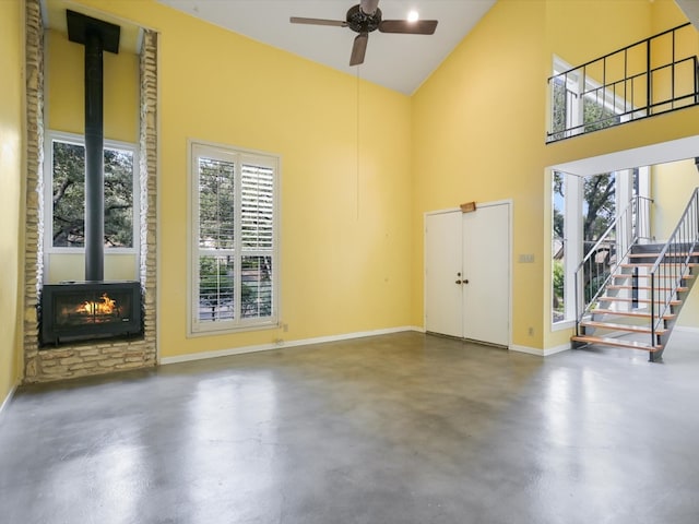 interior space featuring ceiling fan and a wood stove