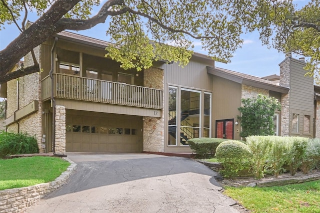 view of front of home featuring a balcony and a garage