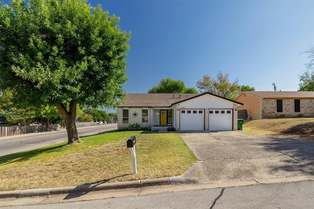 ranch-style home with a front lawn and a garage