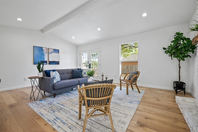 living room featuring french doors, light hardwood / wood-style flooring, and lofted ceiling with beams