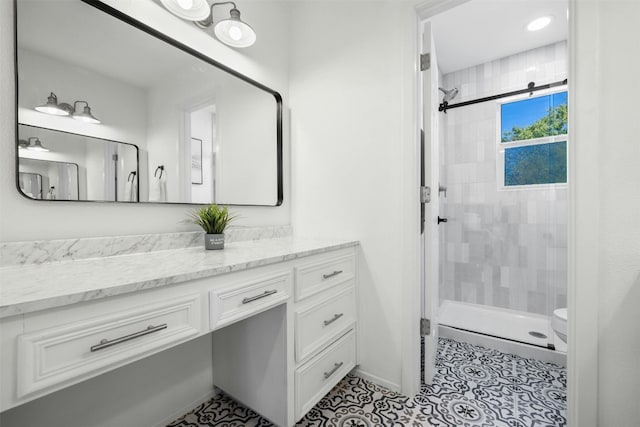 bathroom featuring vanity, walk in shower, and tile patterned flooring