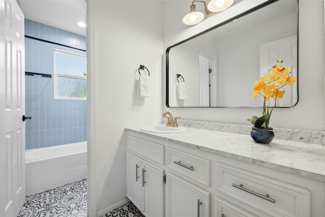 bathroom with tiled shower / bath, vanity, and tile patterned floors