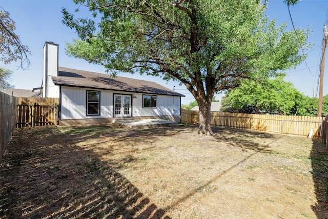 rear view of property featuring french doors