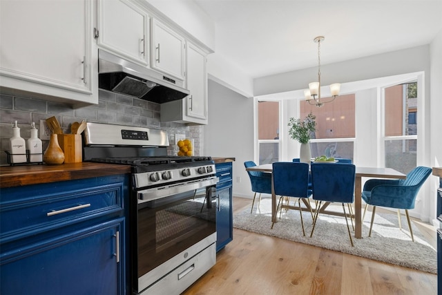 kitchen featuring hanging light fixtures, light wood-type flooring, blue cabinetry, white cabinets, and gas stove