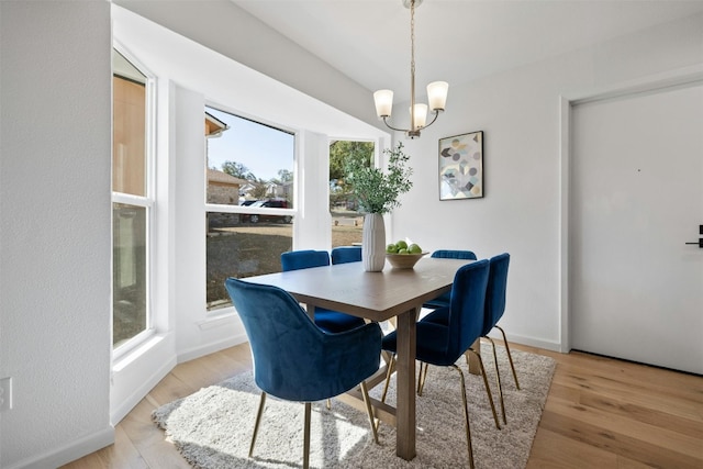 dining room featuring an inviting chandelier and light wood-type flooring