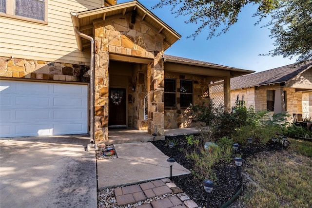 doorway to property with a garage