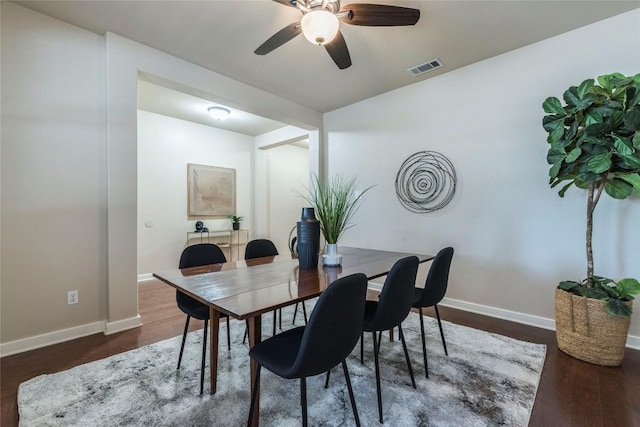 dining room with dark hardwood / wood-style flooring and ceiling fan