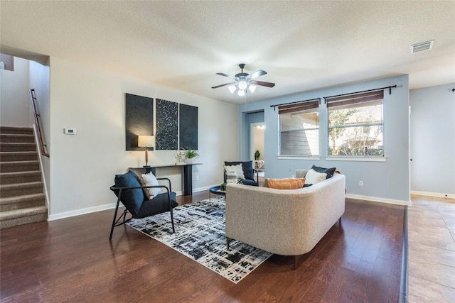 living room with hardwood / wood-style flooring, ceiling fan, and a textured ceiling