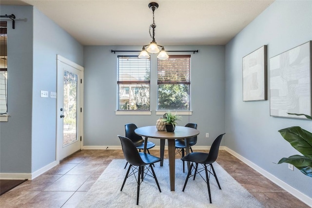 dining room with tile patterned floors and a chandelier