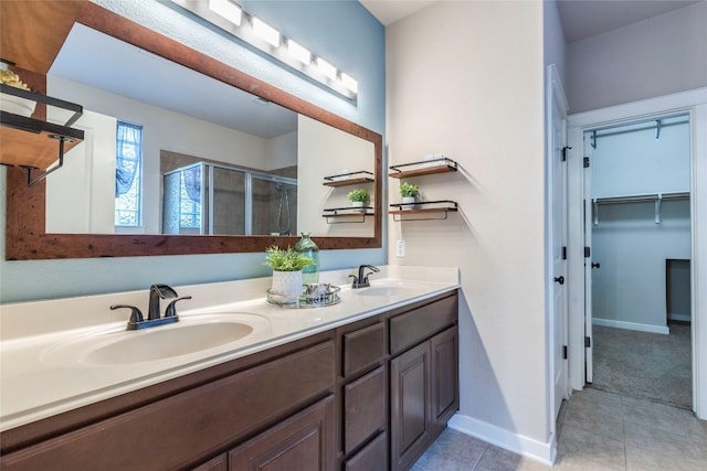 bathroom with tile patterned floors, vanity, and walk in shower