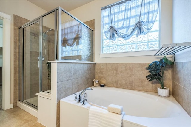 bathroom featuring tile patterned floors and shower with separate bathtub