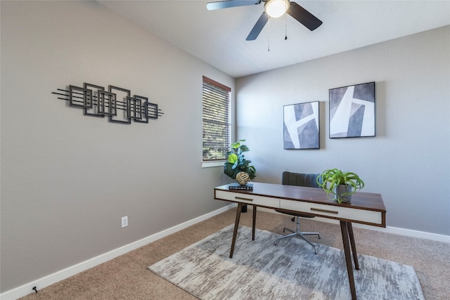 carpeted office space with ceiling fan