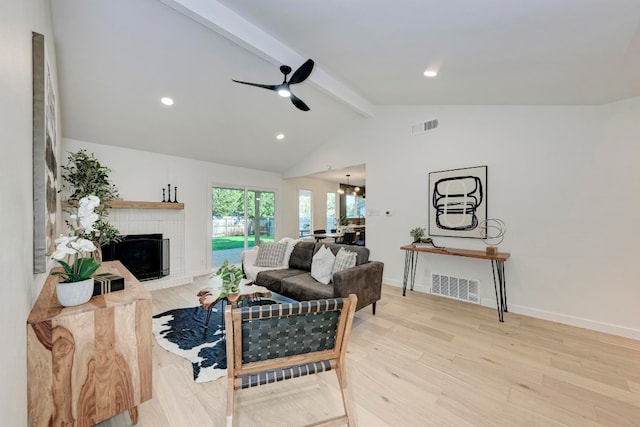 living room with light wood-type flooring, vaulted ceiling with beams, and ceiling fan with notable chandelier